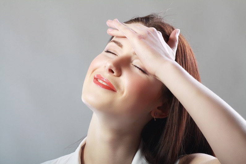 Young woman stressed have a head pain and feels releaf after pain