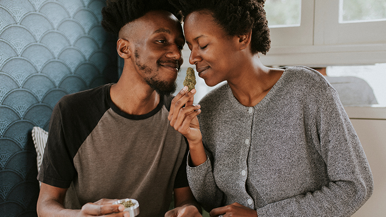 A couple rolling a joint