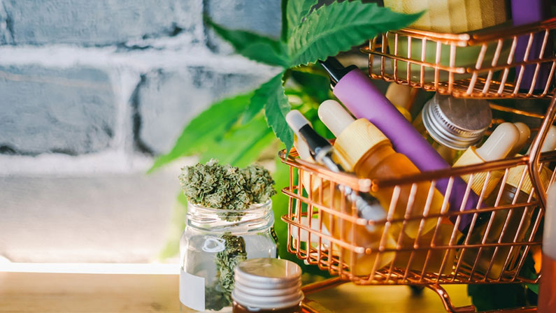 Mini shopping cart with various Medical Cannabis products on table, Shopping purchase concept of Marijuana supplements