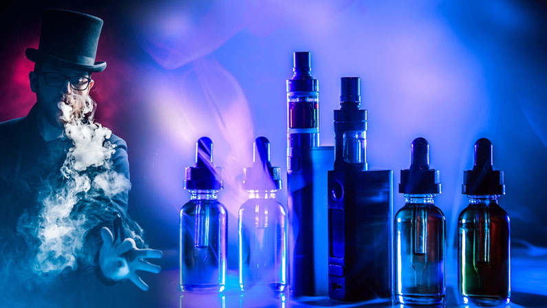 Vaping. VAPE shop. Young guy smokes vape. Smoking e-cig. Vaper on dark background. Smoker on background of VAPE devices. Clouds of smoke from vaping device. Buying vaping juices. Electronic cigarette