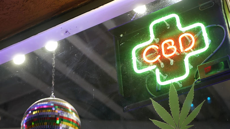 Neon sign in smoke shop, legalized cbd oil or medical cannabis in store, California USA. Legal sale of cannabidiol, weed, hemp, marijuana, ganja or hashish in dispensary. Cannabinoids in drugstore.
