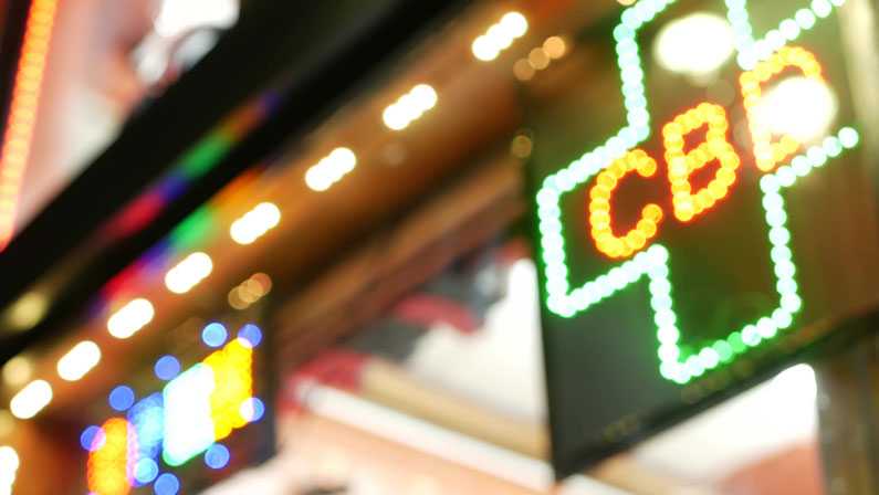 Neon sign in smoke shop, legalized cbd oil or medical cannabis in store, California USA. Legal sale of cannabidiol, weed, hemp, marijuana, ganja or hashish in dispensary. Cannabinoids in drugstore.