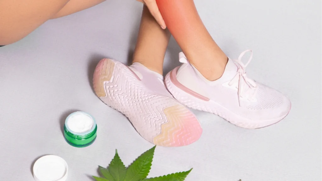 CBD ointments designed for athletes to treat muscle discomfort, woman applying cream made from cannabis extract over injured Calf leg, medical pain treatment. Isolated on gray background