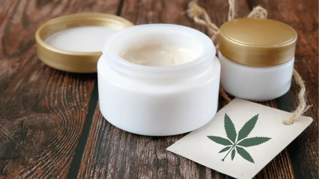 Jar of hemp white lotion. Detail of cannabis cream with marijuana leaf - cannabis topicals concept. Cream from biological and ecological plants of hemp vegetable pharmaceutical oil CBD